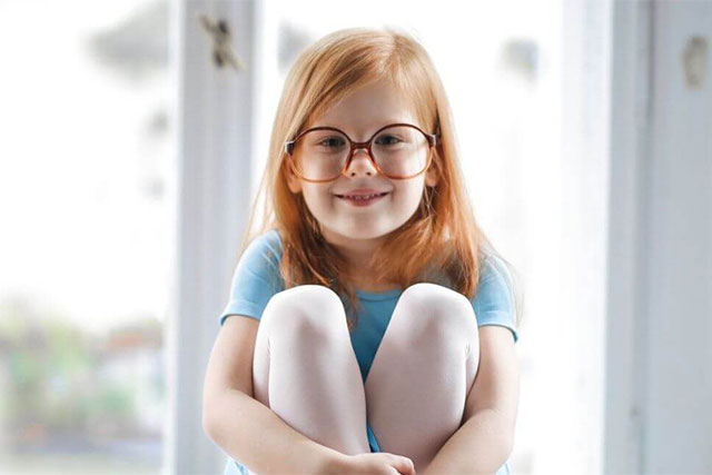 child girl redhead smiling glasses blue ballet dress
